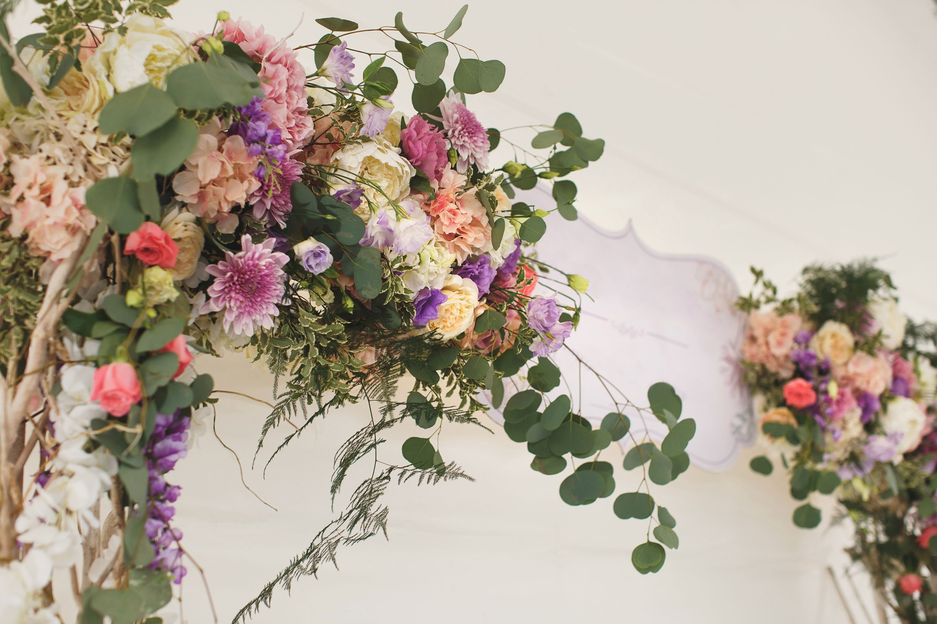 Wedding arch decorated with fresh flowers..